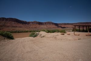 Gravel loading area at Lower Onion Creek with a loading-and-unloading-only sign, shade pavilion right and river left.