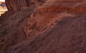 The Mineral Bottom switchbacks, a graded dirt road cut in tight stacked turns down the red canyon wall.
