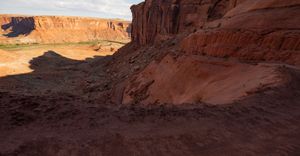 View from partway down the Mineral Bottom switchbacks to the green river bench and flats far below.