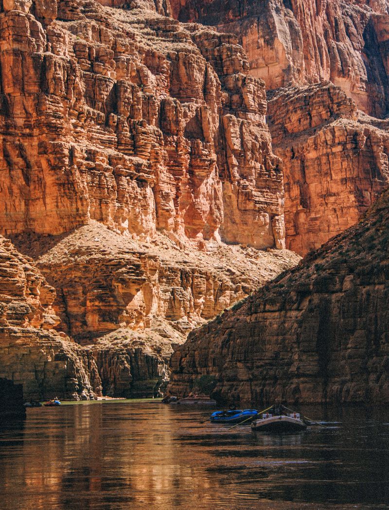 Late afternoon light on a towering tier of red and cream canyon wall in the Grand Canyon