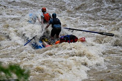 An oar raft is buried in an exploding hole at Last Chance Rapid in Westwater Canyon