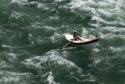 A dory dropping through Red Creek Rapid at high water, seen from the scout above.