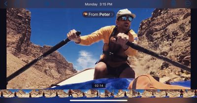 Screenshot of a phone playing a shared video: a rower in a yellow sun shirt pulls on both oars as the boat drops into a rocky rapid, with playback controls and a filmstrip visible.