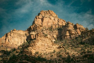 A sandstone peak glowing in late light above darkening canyon walls.