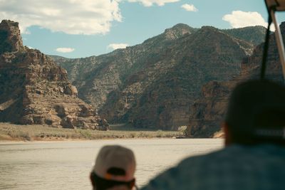 View downstream from the oar seat as the canyon opens into a wider corridor with layered walls.