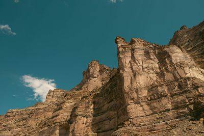 Hoodoo towers and spires silhouetted against a pale teal sky.