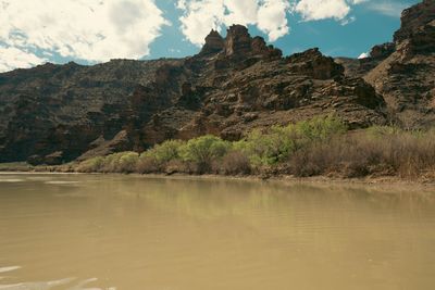 A towering sandstone cliff face with clean horizontal strata.