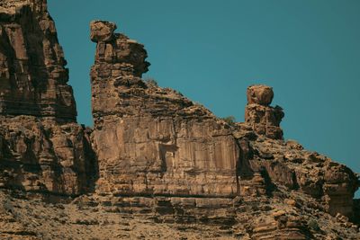 Twin hoodoo towers with balanced capstones on the canyon rim.