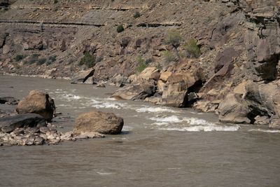 Whitewater threading between house-sized boulders at Three Fords Rapid at low water.