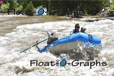 A blue oar raft rides up on edge in a brown Snake River rapid, the tube lifting toward the camera and an oar swung out low over the froth, the rower dropped behind the frame seat while two crew hang on at the stern and conifers line the far bank.